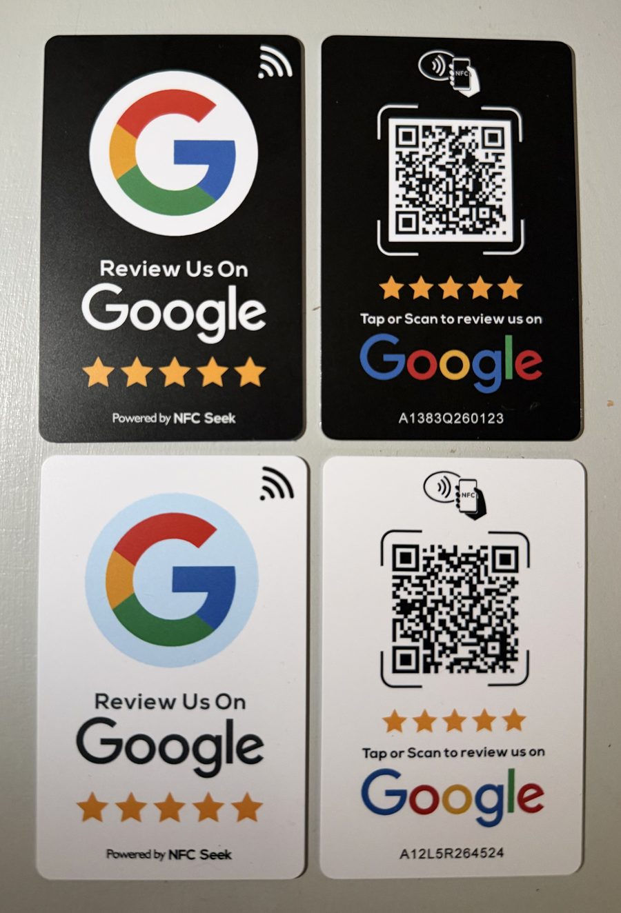 Google review cards in black and white. Front: Review Us On Google with five stars and an NFC tap symbol. Back: QR code with Tap or Scan to review us on Google